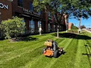 Lawn maintenance professionals caring for a neatly landscaped property in Sullivan, WI